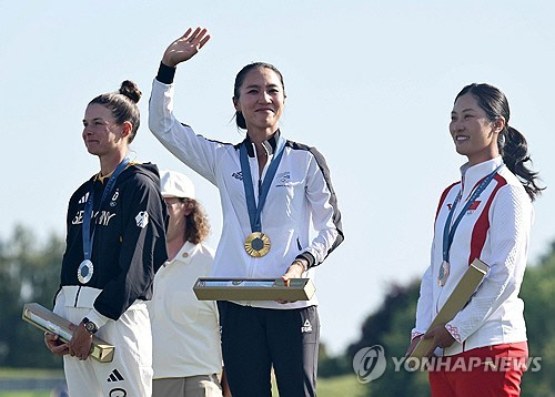 10일(현지시간) 프랑스 파리 인근 기앙쿠르의 르골프 나쇼날에서 열린 2024 파리올림픽 골프 여자 개인전에서 우승한 뉴질랜드의 리디아 고가 시상대에 올라 금메달을 받은 뒤 팬들에게 인사하고 있다.  [기앙쿠르(프랑스)=연합뉴스]